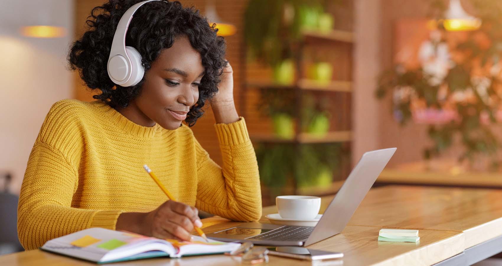 woman with headphones taking online course