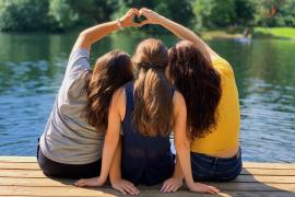group of people making a heart with their hands