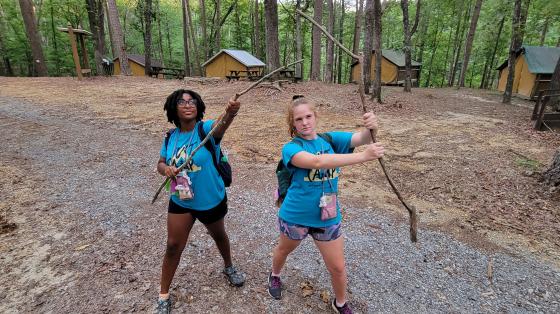 camp staff holding sticks
