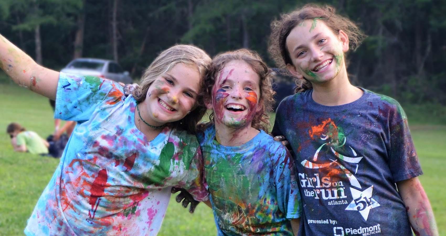 Campers covered in paint smiling for camera