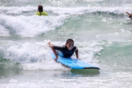 camper riding surf board