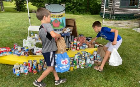 campers tacking canned goods