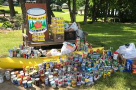 canned goods stacked in canoe and table